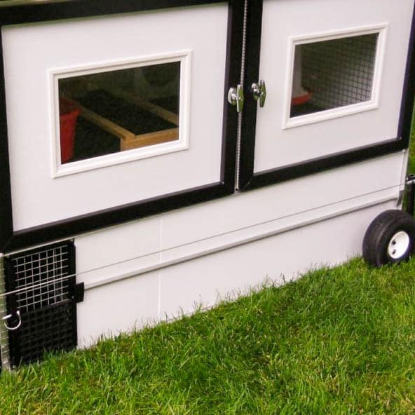 front of practical lightweight classic chicken tractor in the yard with panels on the bottom 1