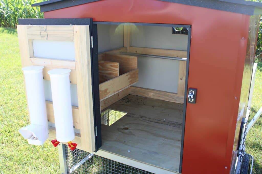 red chicken coop feeder and waterer