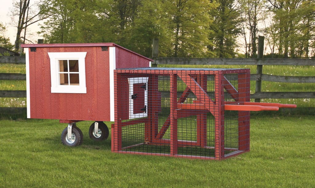 red and white lean to tractor chicken coops in Nebraska with outdoor run