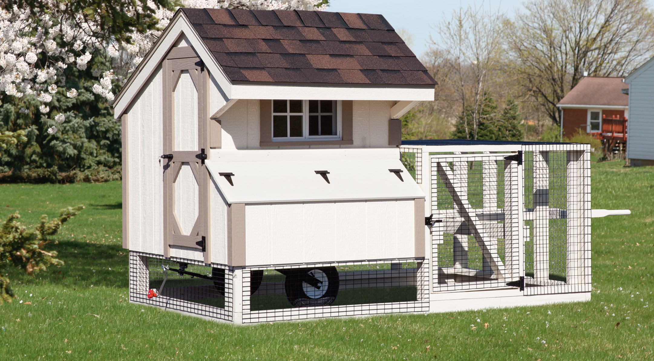 white and tan trimmed chicken coop with outdoor run